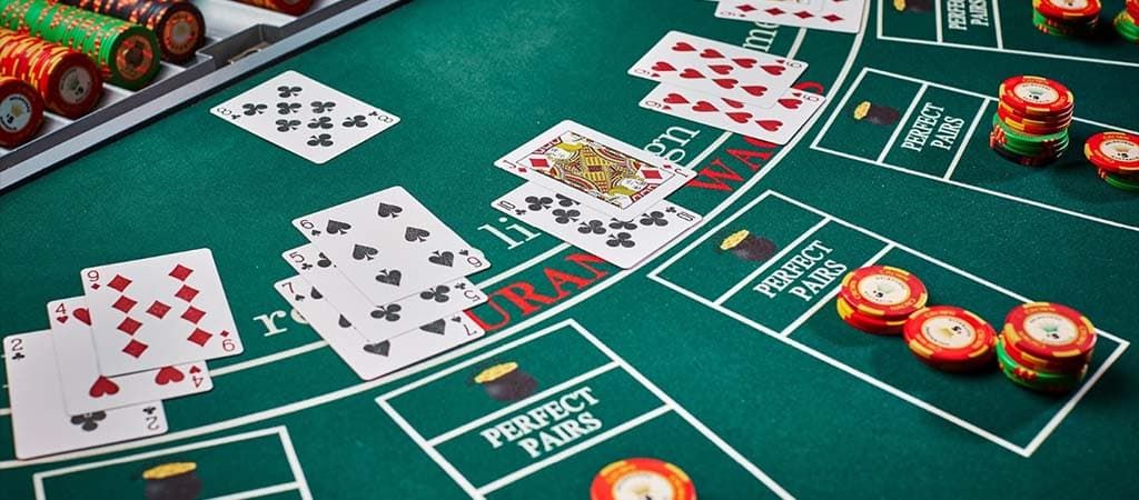 Blackjack asztal zsetonokkal és kártyákkal, élő kaszinó játék izgalmas pillanata.